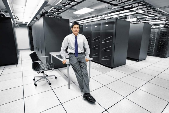 Portrait of a businessman inside a server room.