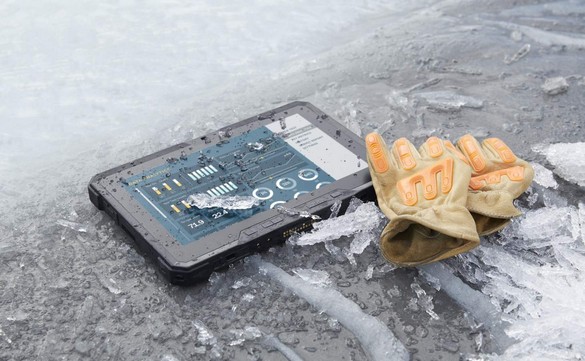 A Dell Latitude 12 Rugged Tablet (Model 7202) computer resting on a frozen stream with shards of ice surrounding it and a pair of orange gloves partially resting on the tablet.