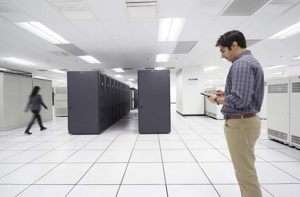 Man in a Large Data Center, Using Venue Tablet