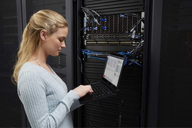 Woman in Data Center with Latitude 14 7000 Series Touch Notebook